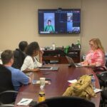 long shot of RHD faculty viewing a presentation