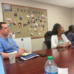 Medium shot of RHD faculty viewing a presentation