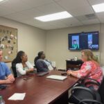 medium shot of RHD faculty viewing a presentation