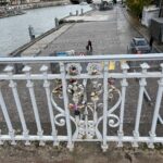 a Paris city balcony view looking at both a river and city street